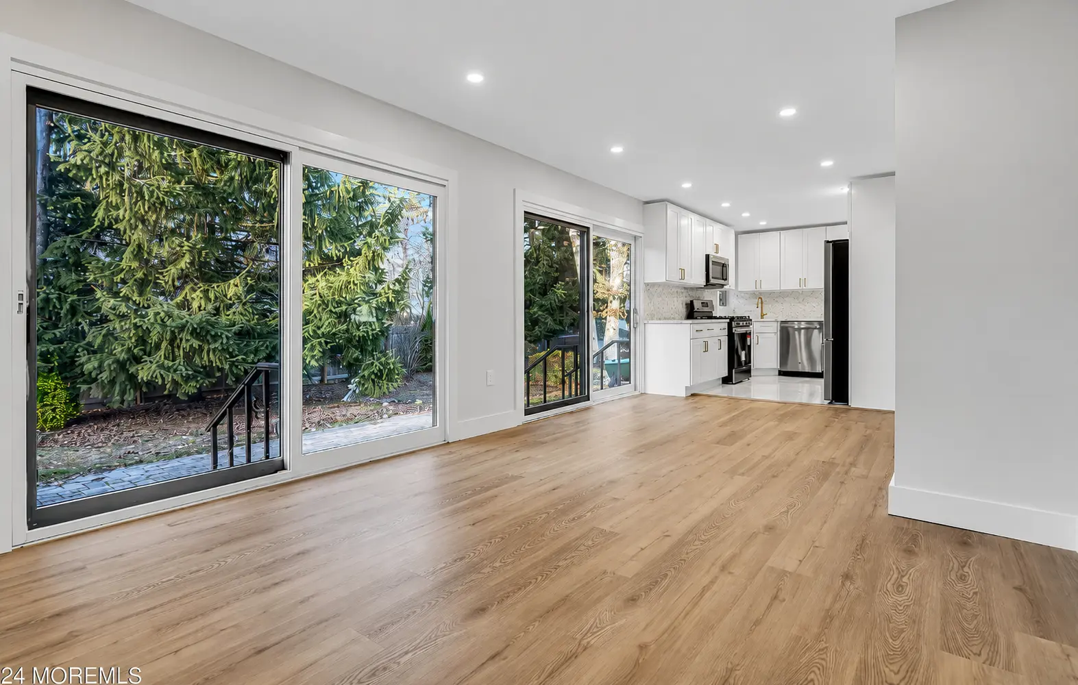 Open-plan addition with oversized sliding glass doors onto the yard